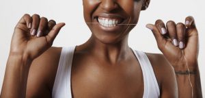 woman using dental floss