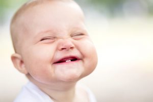 smiling baby with two teeth